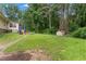 Spacious backyard with a shed, surrounded by lush greenery, offering privacy and potential for outdoor activities at 137 Trickum Hills Dr, Woodstock, GA 30188