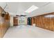 Spacious basement featuring paneled walls, carpet flooring, and a drop ceiling with some ceiling tiles missing at 137 Trickum Hills Dr, Woodstock, GA 30188