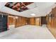 Expansive basement with paneled walls, worn carpet, and some exposed ceiling, offering great potential at 137 Trickum Hills Dr, Woodstock, GA 30188