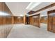 Large basement area featuring paneled walls, carpet flooring, and exposed ceiling sections with visible ductwork at 137 Trickum Hills Dr, Woodstock, GA 30188