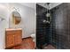 Bathroom features a tiled shower, vanity, and dark tile flooring at 137 Trickum Hills Dr, Woodstock, GA 30188