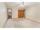 Spacious bedroom with an ensuite bathroom, closet, carpeted flooring, and neutral color scheme at 137 Trickum Hills Dr, Woodstock, GA 30188