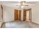 Bedroom featuring carpeted flooring, natural lighting, a ceiling fan, and wood doors at 137 Trickum Hills Dr, Woodstock, GA 30188