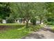 Charming home with a well-maintained front yard, mature trees, and a driveway; includes a detached garage at 137 Trickum Hills Dr, Woodstock, GA 30188