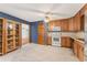 Well-lit kitchen showcases stylish cabinets, tiled floor, and seamless flow to a separate living area at 137 Trickum Hills Dr, Woodstock, GA 30188