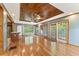 Bright living room with hardwood floors, wood ceiling, recessed lights, and access to kitchen at 137 Trickum Hills Dr, Woodstock, GA 30188