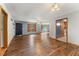 Spacious living area featuring wood floors, seamless transitions to kitchen and views of outdoor spaces at 137 Trickum Hills Dr, Woodstock, GA 30188