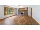 Bright living room with fireplace, large windows, and wood floors offers a cozy and inviting atmosphere at 137 Trickum Hills Dr, Woodstock, GA 30188