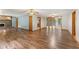 Spacious living room features sleek wood floors, a classic brick fireplace, and seamless access to kitchen and back deck at 137 Trickum Hills Dr, Woodstock, GA 30188