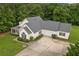 Aerial view of a traditional house with a large driveway, lush landscaping, and attached garage at 2333 Old Newnan Rd, Carrollton, GA 30116