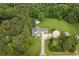 Aerial view of the traditional home with detached garages and lush, wooded landscape at 2333 Old Newnan Rd, Carrollton, GA 30116
