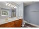 A primary bathroom has wood cabinets, double sinks, a soaking tub, and a glass-enclosed shower at 2333 Old Newnan Rd, Carrollton, GA 30116