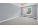 Bedroom with carpeted floors, ceiling fan, and a large window at 2333 Old Newnan Rd, Carrollton, GA 30116