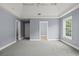 A primary bedroom has plush carpet, a tray ceiling, and natural light from a window at 2333 Old Newnan Rd, Carrollton, GA 30116