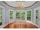 Bright dining room features hardwood floors, chandelier, and large windows with a view of the wooded yard at 2333 Old Newnan Rd, Carrollton, GA 30116
