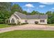 Well-maintained home featuring an attached garage, a lush lawn, and mature trees at 2333 Old Newnan Rd, Carrollton, GA 30116