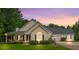 Charming single-Gathering home with inviting front porch and lush green lawn at sunset at 2333 Old Newnan Rd, Carrollton, GA 30116