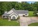 Traditional home featuring a cozy front porch, well-maintained landscaping, and attached garage at 2333 Old Newnan Rd, Carrollton, GA 30116