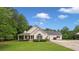 A single-Gathering home with a charming front porch and detached garage on a lush green lawn at 2333 Old Newnan Rd, Carrollton, GA 30116