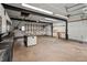 Spacious garage featuring a workbench, cabinets, and bright overhead lighting at 2333 Old Newnan Rd, Carrollton, GA 30116