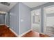 Hallway with hardwood floors leads to a bedroom and bathroom at 2333 Old Newnan Rd, Carrollton, GA 30116