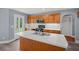 This kitchen features stainless appliances, wood cabinets, a white countertop, and a door to the backyard at 2333 Old Newnan Rd, Carrollton, GA 30116