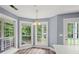 An open kitchen features wood cabinets, a chandelier, and large windows with a wooded view at 2333 Old Newnan Rd, Carrollton, GA 30116