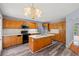 A kitchen features wood cabinets, a kitchen island with white countertops, and stainless appliances at 2333 Old Newnan Rd, Carrollton, GA 30116