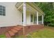 Covered porch with brick accents and steps leading to the backyard at 2333 Old Newnan Rd, Carrollton, GA 30116