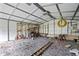 Unfinished interior of a shed with a gravel floor and lots of storage and shelving at 2333 Old Newnan Rd, Carrollton, GA 30116