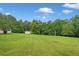 Large grassy lot with mature trees and outbuilding offers plenty of outdoor space at 2333 Old Newnan Rd, Carrollton, GA 30116