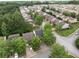 An aerial view of a neighborhood featuring well-maintained homes, lush trees, and manicured lawns on a sunny day at 3063 Broadleaf Trl, Fairburn, GA 30213
