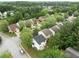 Aerial view of a residential area showcasing a white two story home and tree coverage at 3063 Broadleaf Trl, Fairburn, GA 30213