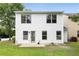 Two story home with a well maintained backyard and a small concrete patio at 3063 Broadleaf Trl, Fairburn, GA 30213
