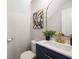 Stylish powder room with navy vanity, modern mirror, and gold hardware at 3063 Broadleaf Trl, Fairburn, GA 30213