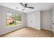 Airy bedroom featuring natural light, a ceiling fan, spacious closet and modern flooring at 3063 Broadleaf Trl, Fairburn, GA 30213