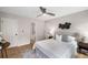 Bedroom with plush bed, ceiling fan, and ensuite bath at 3063 Broadleaf Trl, Fairburn, GA 30213