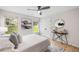 Bedroom with plush bed, ceiling fan, natural light and a decorative mirror at 3063 Broadleaf Trl, Fairburn, GA 30213