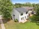 A white two-story home, featuring a dark roof and lush green lawn at 3063 Broadleaf Trl, Fairburn, GA 30213