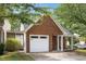 Exterior view of a brick home with an attached one-car garage and an inviting, covered entrance at 3063 Broadleaf Trl, Fairburn, GA 30213