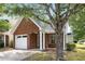Attractive brick home boasting a one-car garage and covered entryway enhanced by white pillars at 3063 Broadleaf Trl, Fairburn, GA 30213