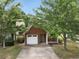 Cozy brick home with a well-manicured lawn, driveway, and a one car garage at 3063 Broadleaf Trl, Fairburn, GA 30213