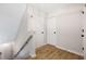 Clean, bright hallway with fresh paint, and a staircase leading to the basement and second floor at 3063 Broadleaf Trl, Fairburn, GA 30213