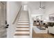 Bright living room with a staircase, open to a kitchen with bar seating and a comfortable living space at 3063 Broadleaf Trl, Fairburn, GA 30213