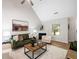 Cozy living room with a fireplace, vaulted ceiling, and stylish decor in an open and airy space at 3063 Broadleaf Trl, Fairburn, GA 30213