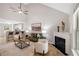 Inviting living room with fireplace, vaulted ceilings, and an open layout connecting to the kitchen area at 3063 Broadleaf Trl, Fairburn, GA 30213