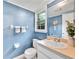Charming blue bathroom with a window and a well-lit vanity at 3107 Bunker Hill Cir, Marietta, GA 30062