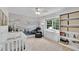 Comfortable Bedroom with mountain mural, crib, chair, and built-in storage at 3107 Bunker Hill Cir, Marietta, GA 30062