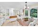 Updated kitchen featuring white cabinets, tile backsplash, a breakfast nook, and a butcher block island at 3107 Bunker Hill Cir, Marietta, GA 30062