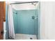 Bathroom shower with turquoise tiling at 5317 Highway 81, Loganville, GA 30052